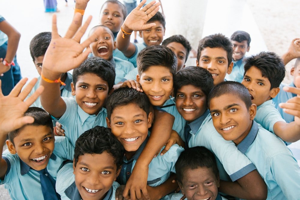 Group of smiling schoolchildren waving