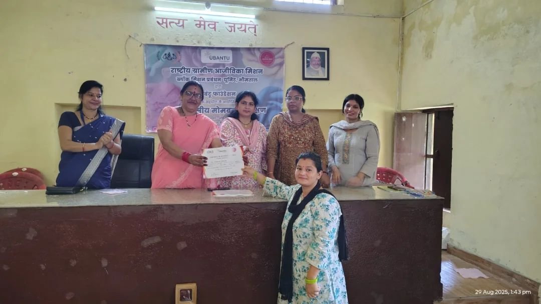 A participant receiving her certificate at the candle making training at Bhimtal, Uttarakhand, completed 2 September 2025