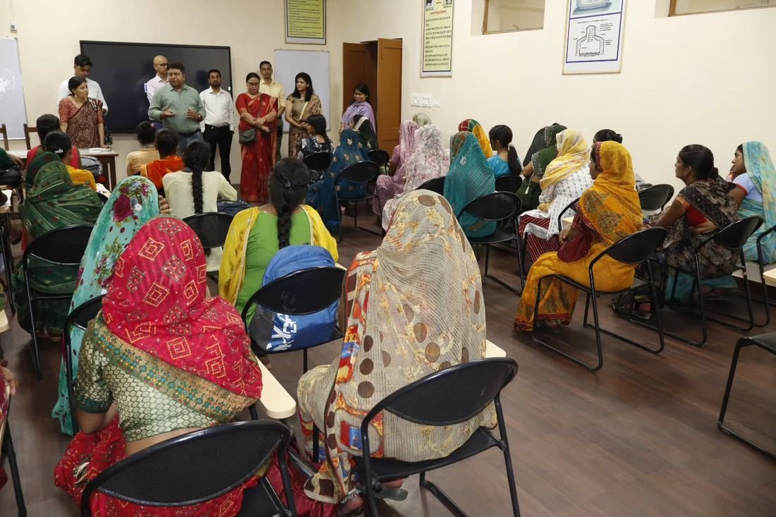Women seated in the training room at the NDDB Dairy Services bio-enzyme and candle making training, Lakhimpur district, Uttar Pradesh
