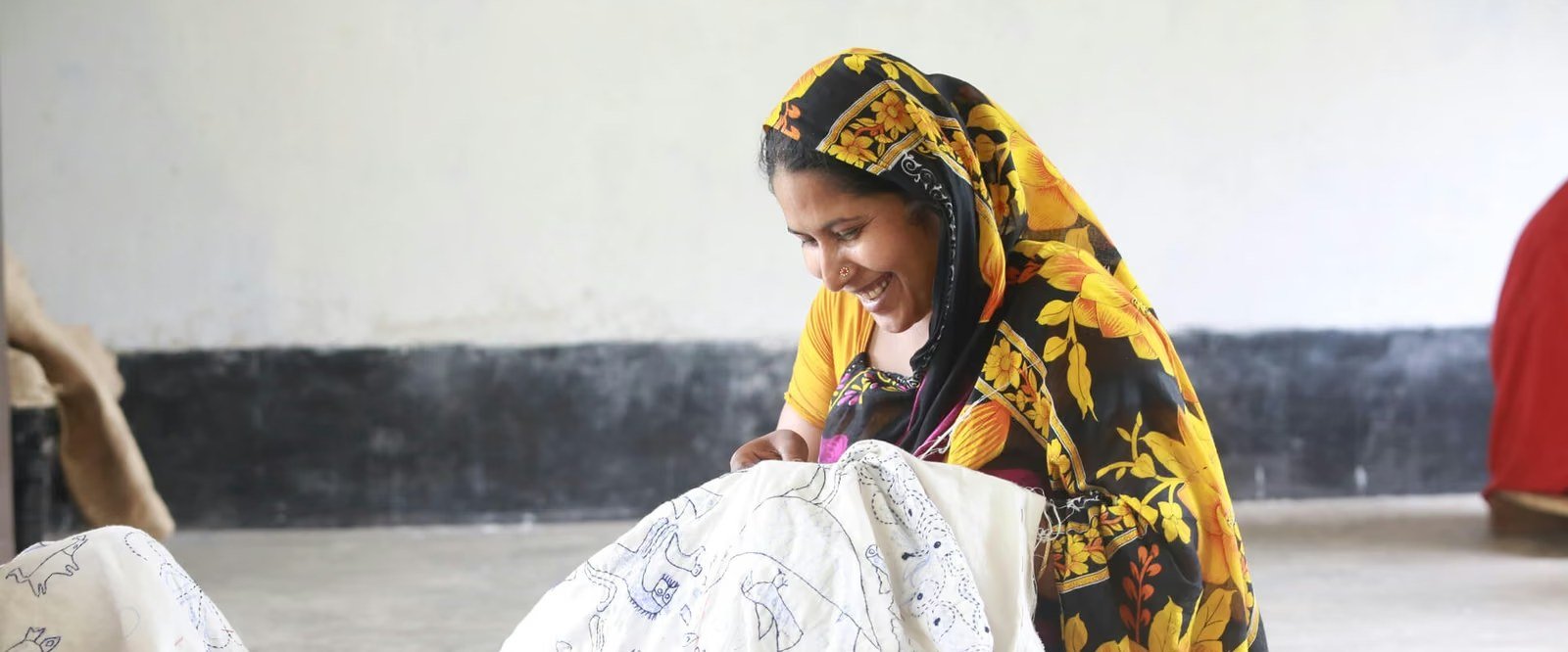 Woman embroidering fabric at a livelihood training session