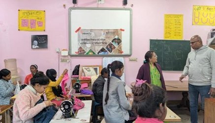 A group of women and girls at sewing machines in Delhi