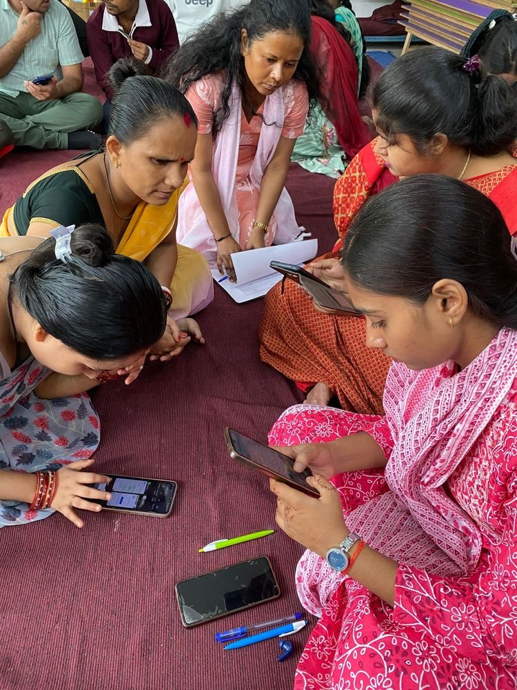 Young women learning to use tablets and smartphones at a digital literacy session