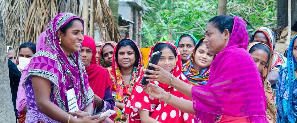 Self-help group members reviewing a digital financial inclusion app together
