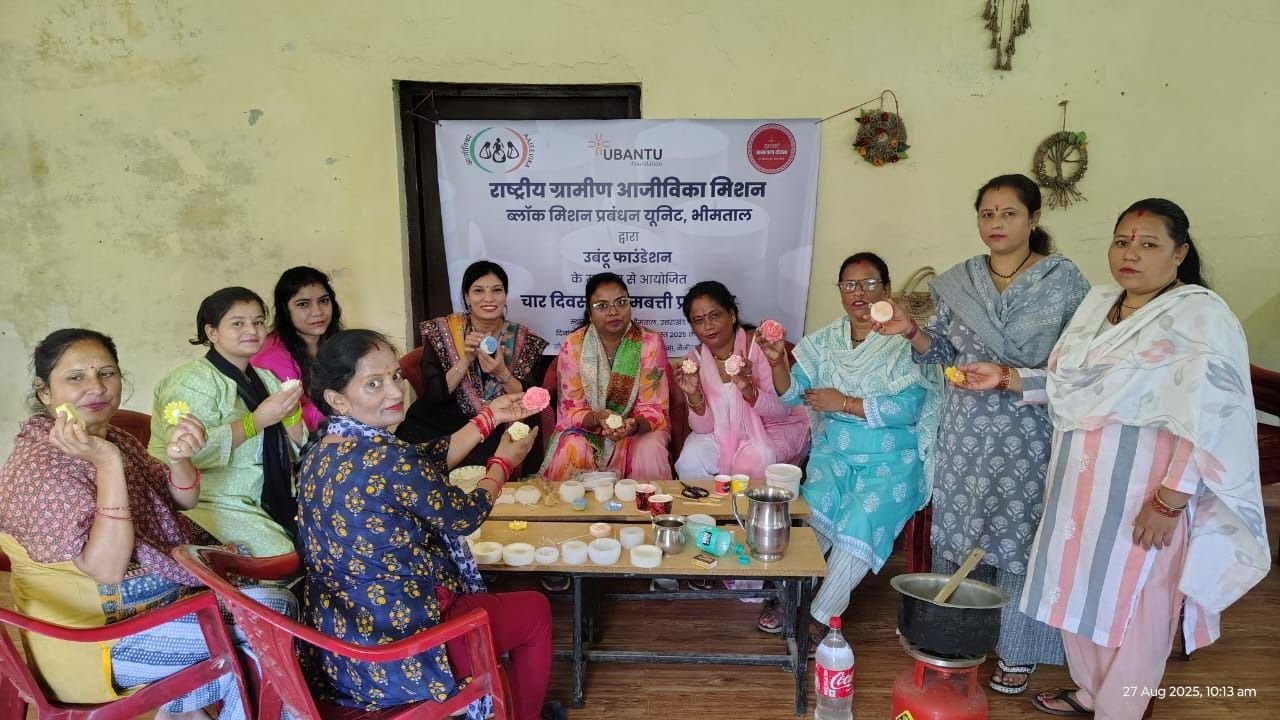 Self-help group members at a training session, with sample products laid out on the table