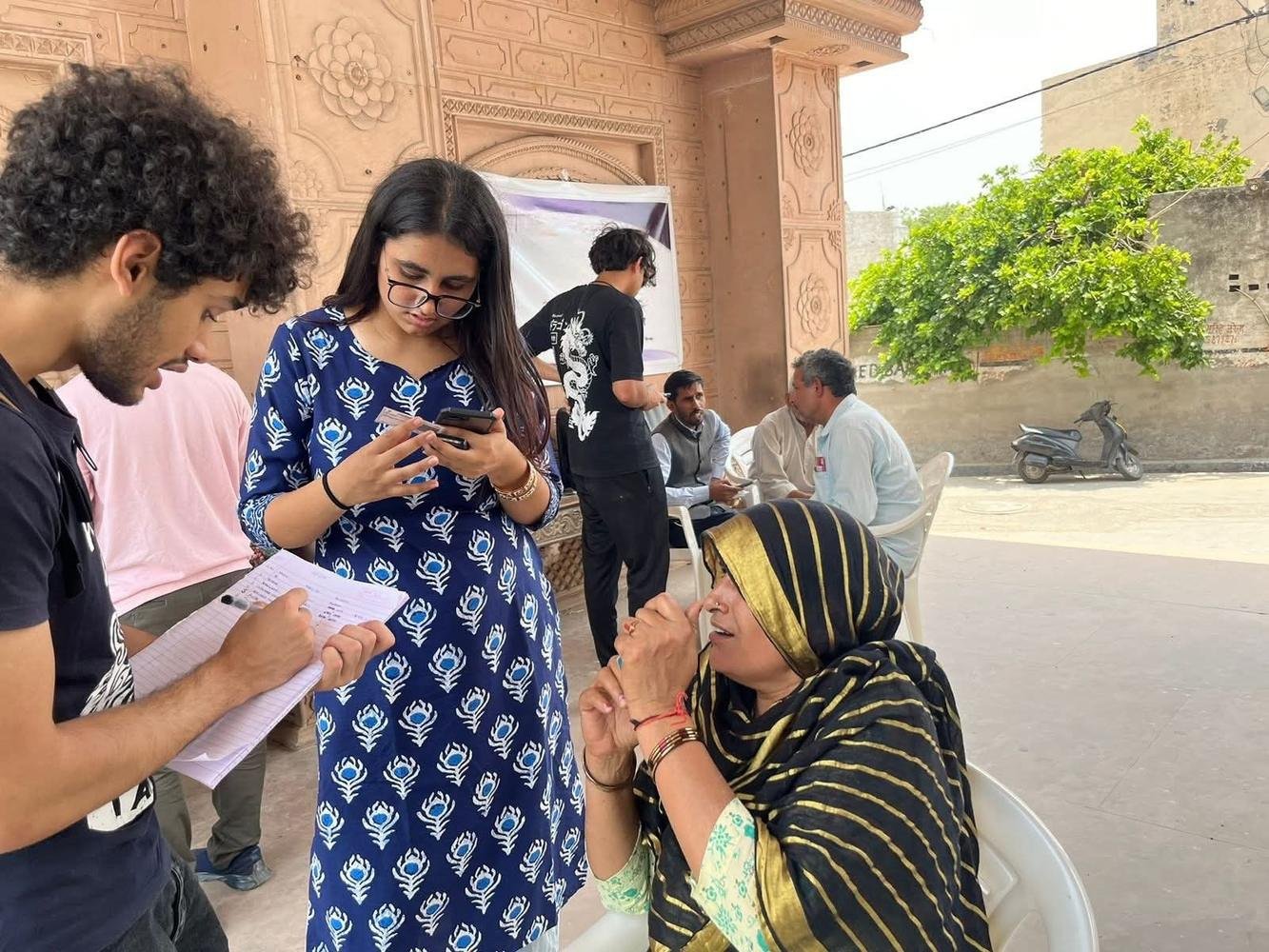 Student interns talking with community members during a field visit