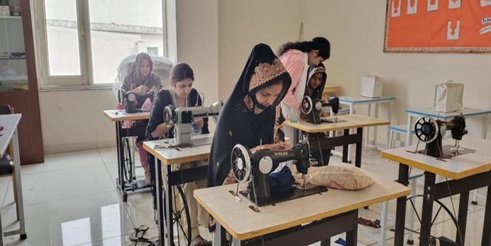 Two women at sewing machines during a stitching training session in Uttar Pradesh