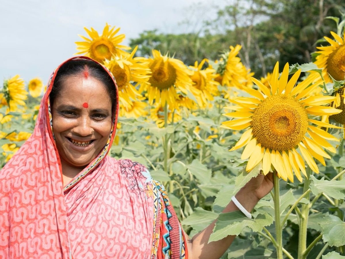 Woman farmer smiling in a sunflower field